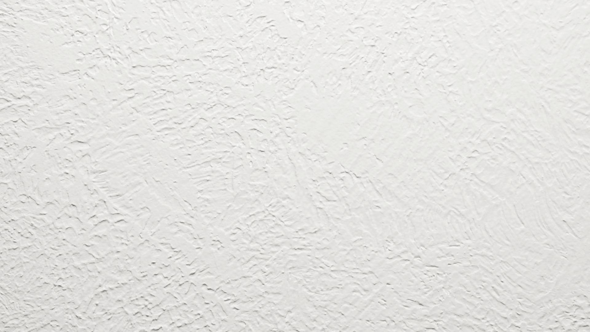Skip trowel drywall texture painted in white with raised patches.