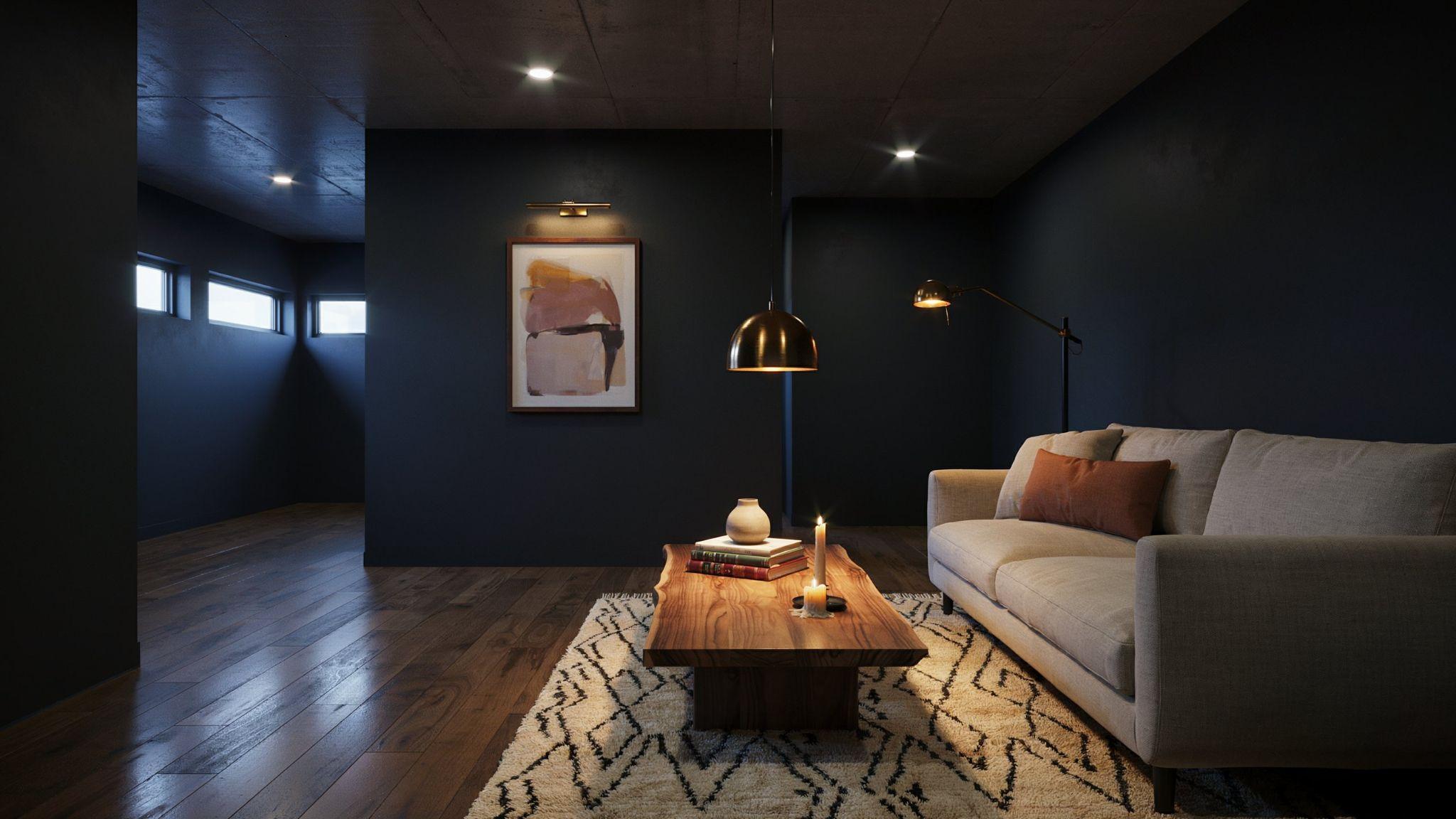 Moody modern basement interior featuring a deep charcoal accent wall influenced by Valspar Gravity with warm lighting and contrasting neutral decor.