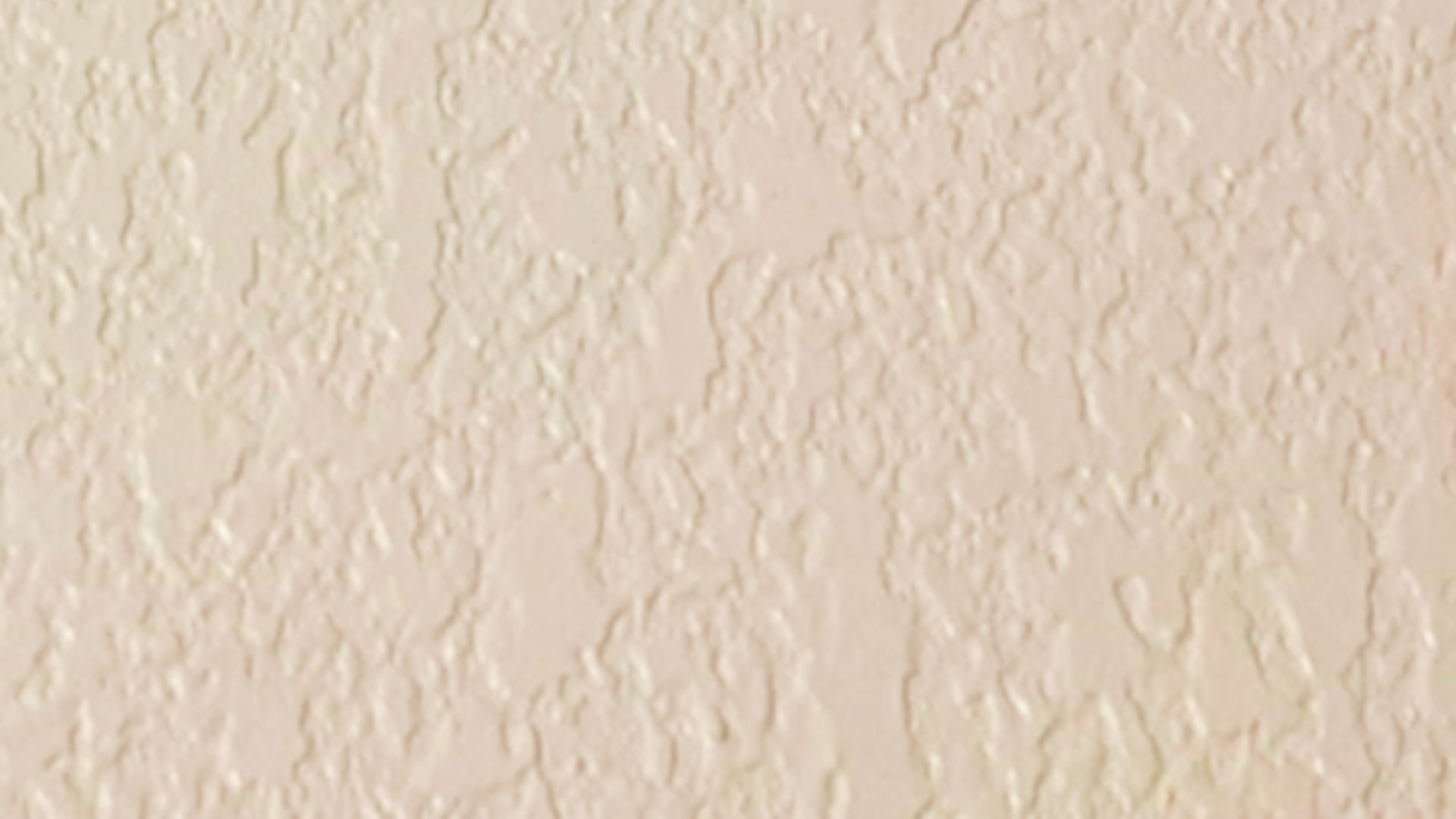 Orange peel drywall texture in beige with a light, pebbled surface.