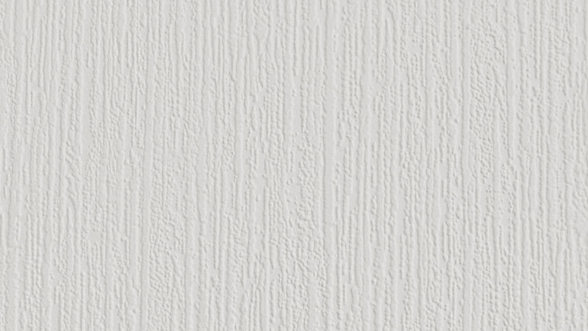 Close-up of a white drywall surface with a vertical tree bark texture.