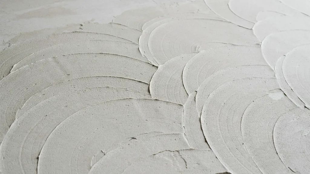 ceiling with skip trowel texture showing uneven layered patches creating rustic Mediterranean style depth and visual interest.