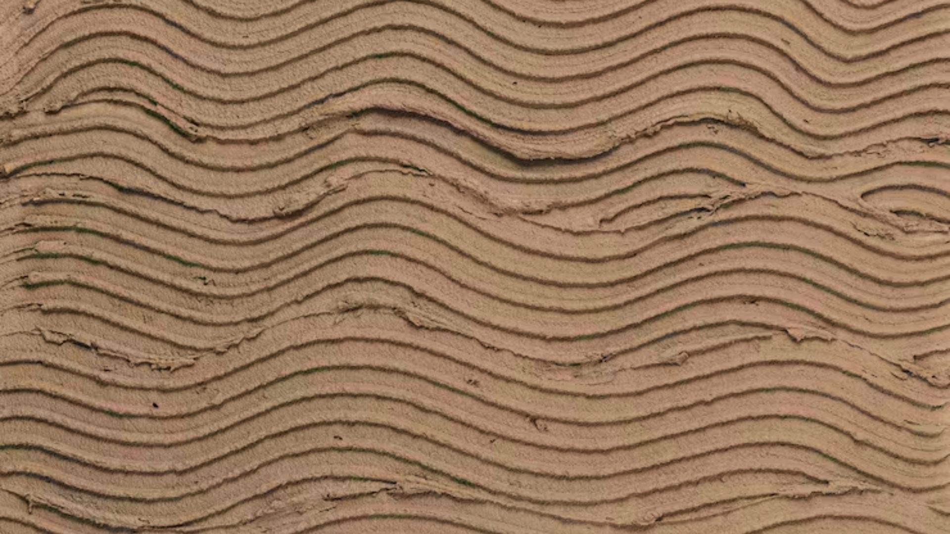 Sand Swirl drywall texture with repeating wavy horizontal lines in brown plaster.
