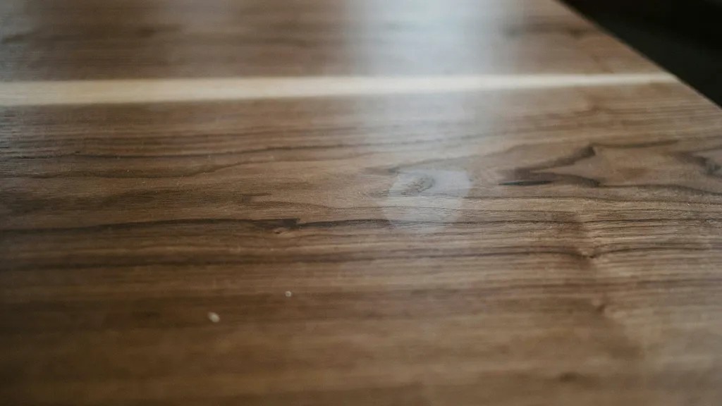 stained furniture surface sealed with protective topcoat showing smooth durable finish with enhanced depth and long lasting protection.