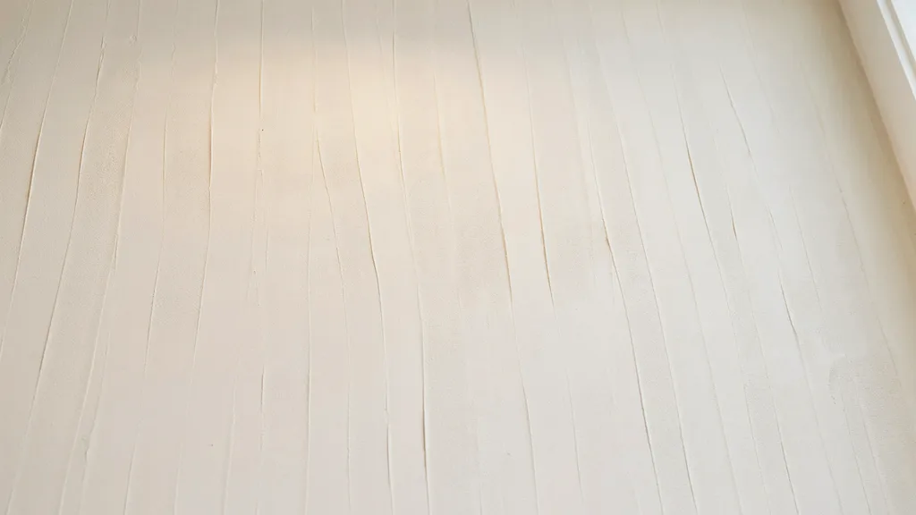ceiling with comb texture showing thin evenly spaced lines creating subtle linear patterns under soft interior lighting.